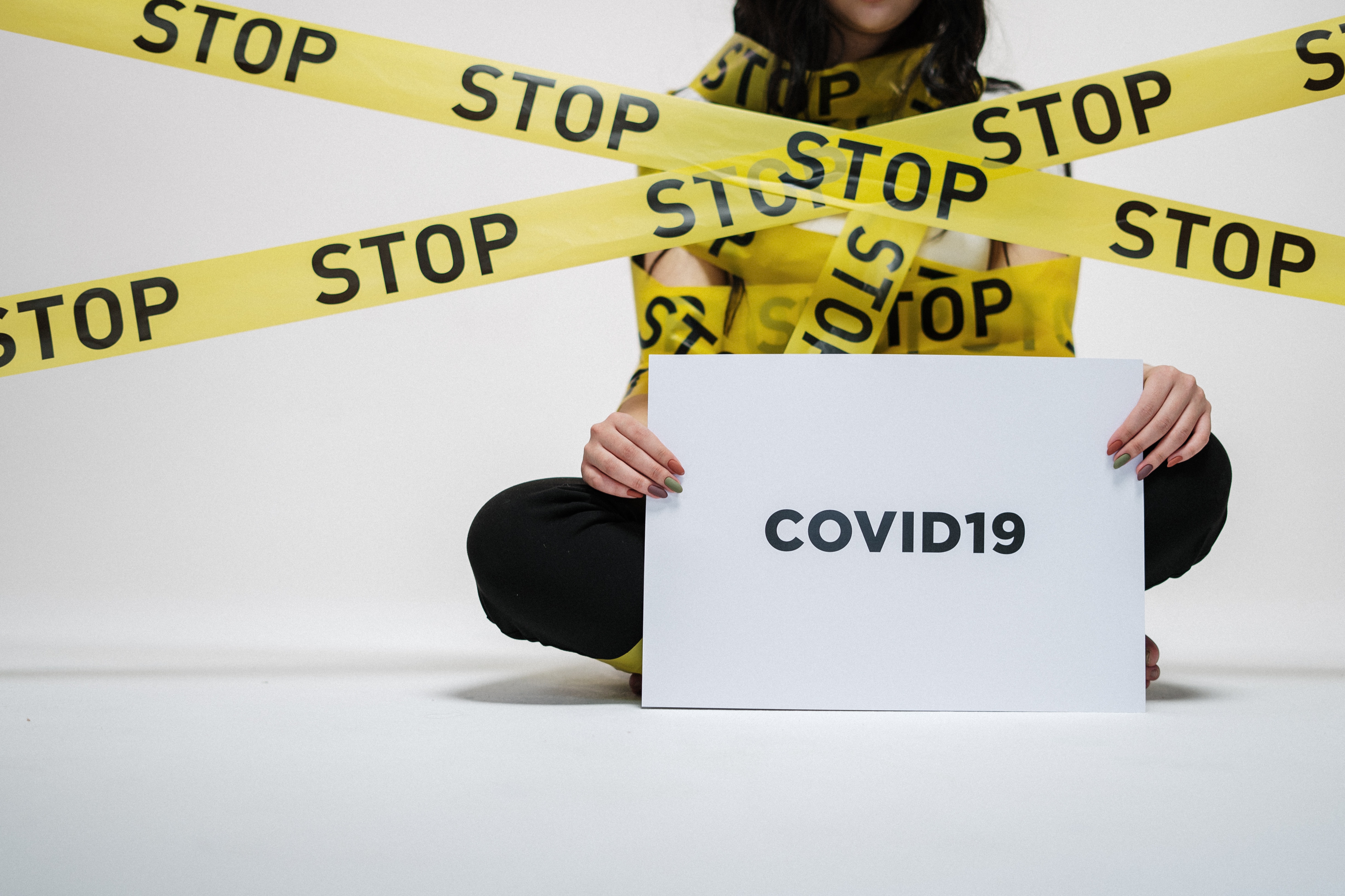 Women holding Covid19 Banner